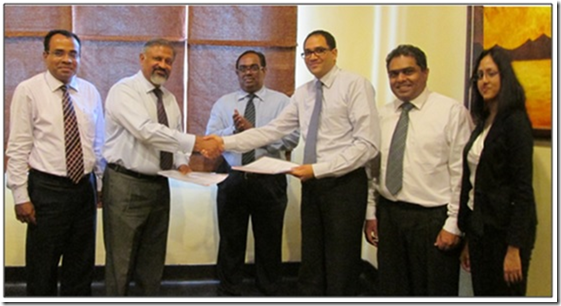 Signing of the agreement between John Keells Research (JKR) and the Human Genetics Unit (HGU) of the Faculty of Medicine, University of Colombo on 5 May 2014: The picture shows the exchange of the agreement between Prof. Rohan W Jayasekara (Former Dean, Faculty of Medicine and Former Director, Human Genetics Unit, Faculty of Medicine, University of Colombo) and Mr. Gihan Cooray (Head of Corporate Finance and Strategy and Executive Vice President, John Keells Group). In the picture from left to right are: Prof. Vajira H. W. Dissanayake (Professor and Medical Geneticist, Human Genetics Unit, Faculty of Medicine, University of Colombo); Prof. Rohan W Jayasekara; Dr. Sunil Jayantha Nawaratne, (Former Secretary, Ministry of Higher Education); Mr. Gihan Cooray; Dr. Muditha Senarath Yapa (Head, John Keells Research); and Ms. Madushani Kannangara (R & D Scientist – Molecular Life Sciences, John Keells Research).